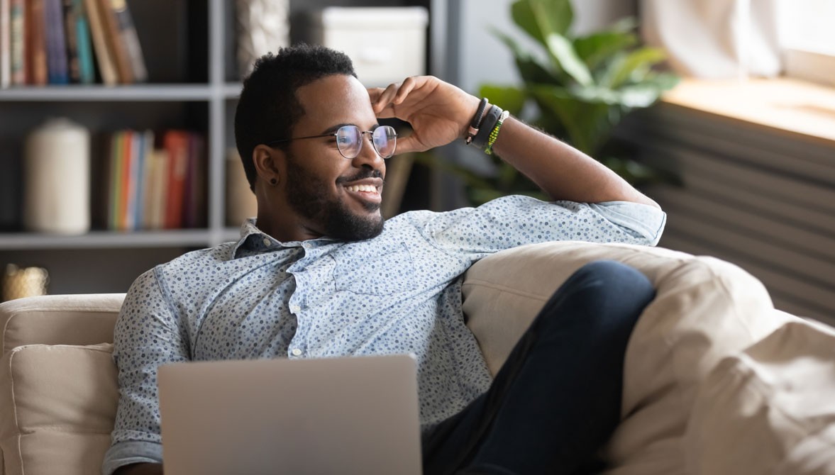 person sitting on couch with laptop