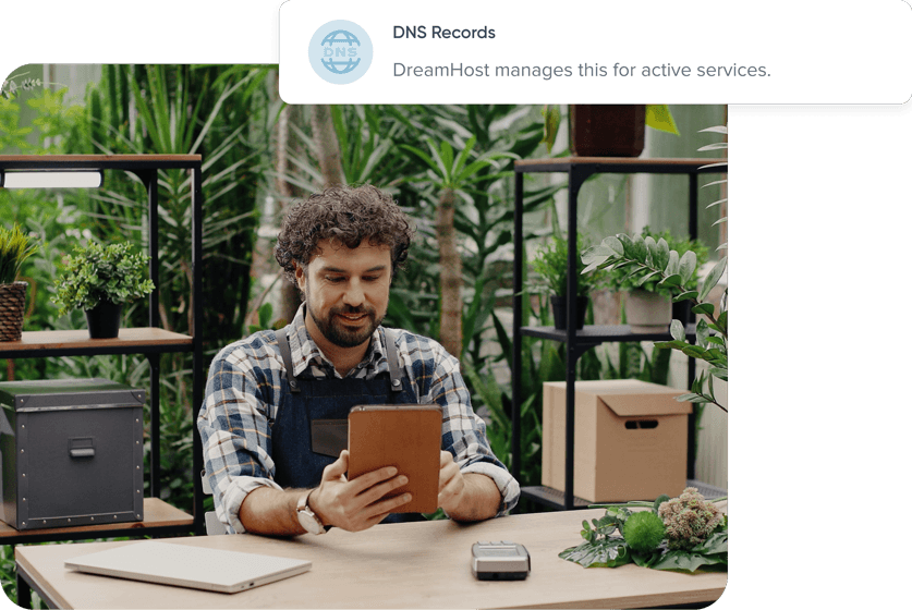 Man working on tablet in workshop setting and DNS Records tag